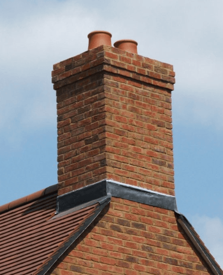 Brick chimney stack on a tiled roof
